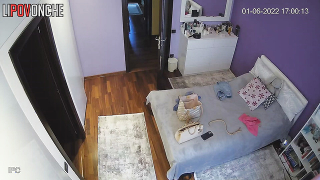 Girl trying on clothes in the bedroom in front of the mirror