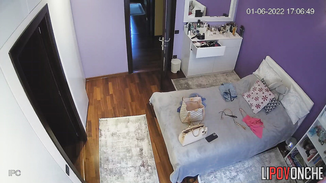 Girl trying on clothes in the bedroom in front of the mirror