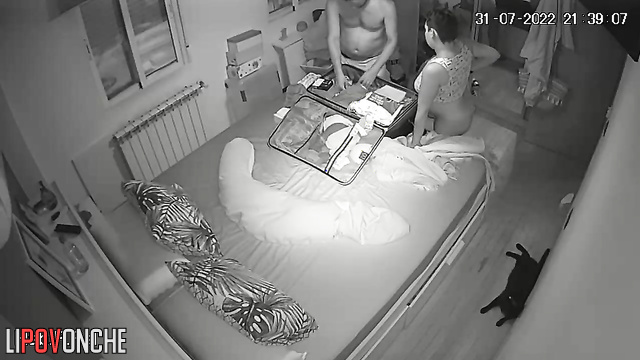 Man and pregnant woman pack suitcases naked in bedroom