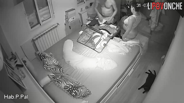 Man and pregnant woman pack suitcases naked in bedroom