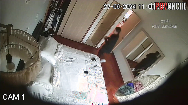 Brunette lies on the bed and masturbates with a vibrator
