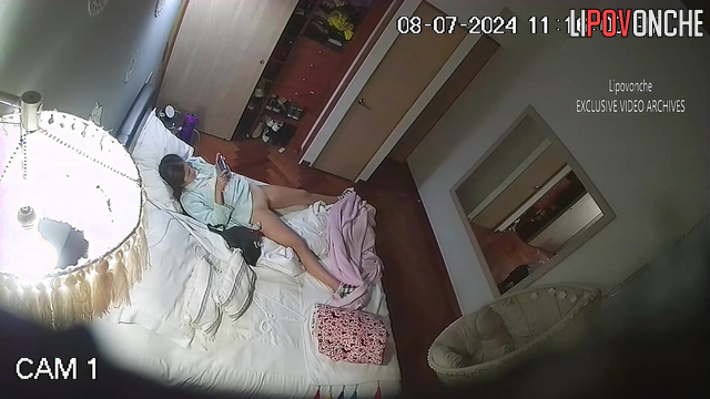 Brunette with long hair masturbates to porn in the bedroom
