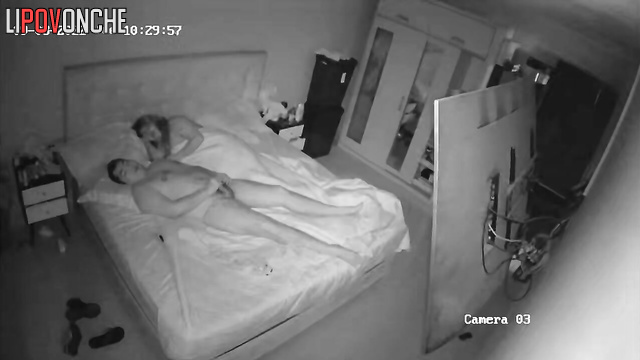 MILF jerks off man and couple fucks on bed in dark bedroom