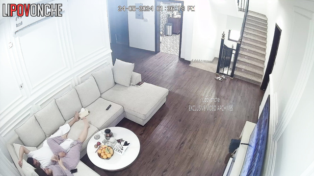 Brunette in pajamas sucks a man's cock in the living room