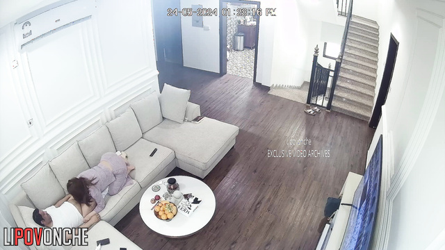 Brunette in pajamas sucks a man's cock in the living room