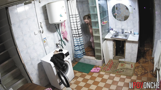 Blonde taking shower in the basement (she is almost naked)
