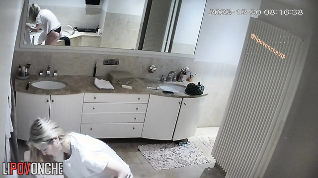 Blonde peeing and stroking her cat at the same time