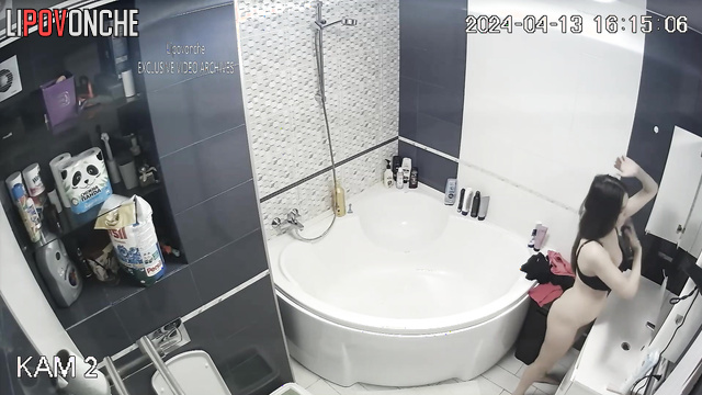 Long-haired brunette dressing on a date after bath taking