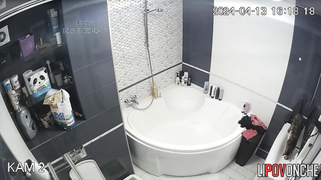 Long-haired brunette dressing on a date after bath taking