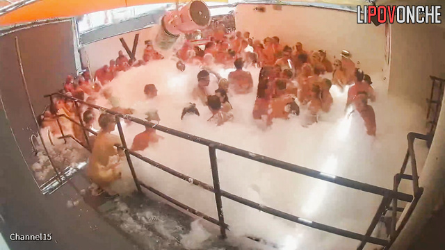 Naked women and men dance in foam at the adult party