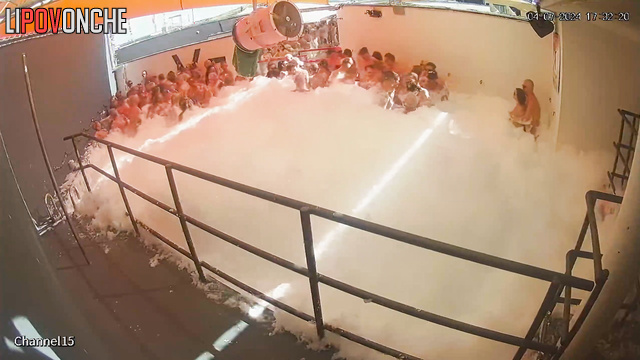 Naked women and men dance in foam at the adult party