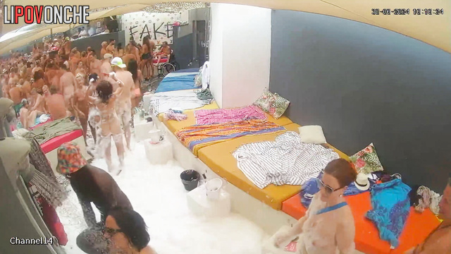 Different people enjoying adult games near the pool