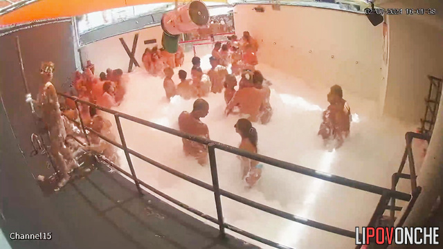 Swingers dancing in the pool in foam, live video