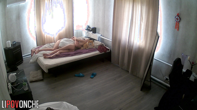 Young couple hugging under the blanket - home video