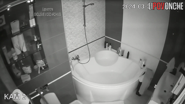 Young couple taking turns showering in the bathroom