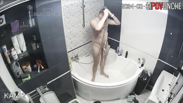 Young couple taking turns showering in the bathroom