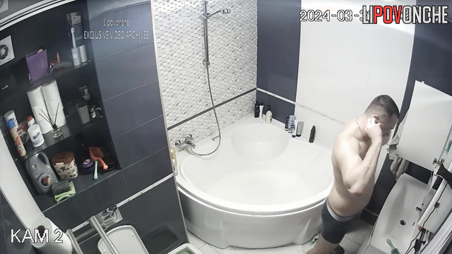 Young couple taking turns showering in the bathroom