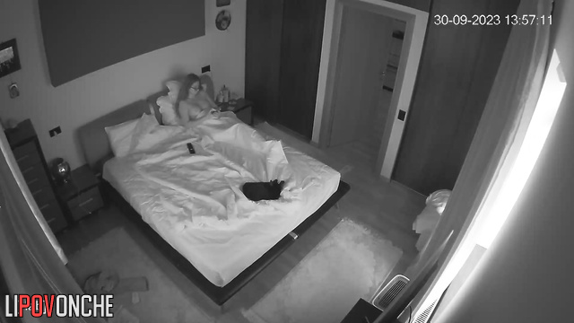Long-haired beauty with glasses fucks her man on the bed