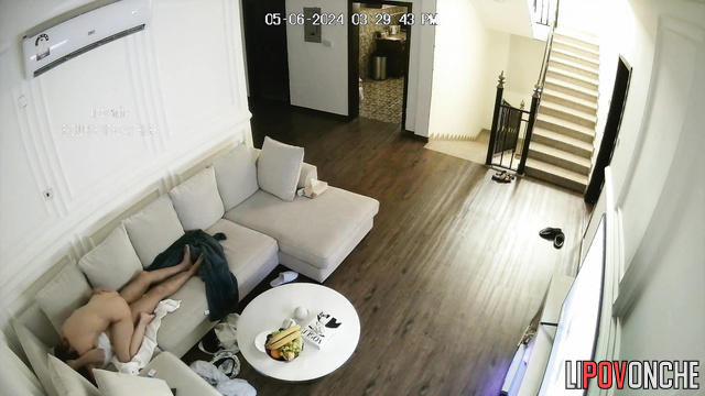 A couple has sex in the living room in front of the TV