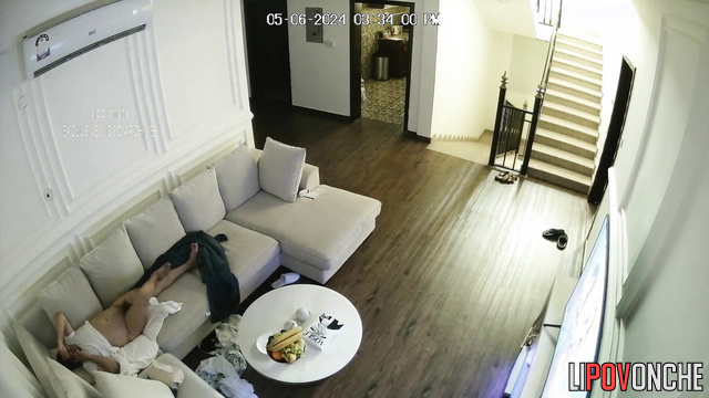 A couple has sex in the living room in front of the TV