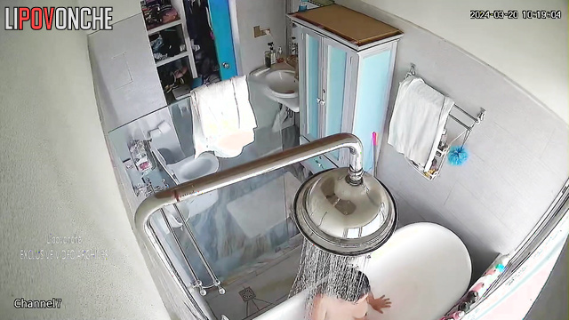 Mature MILF takes a shower and masturbates while sitting in the bathtub