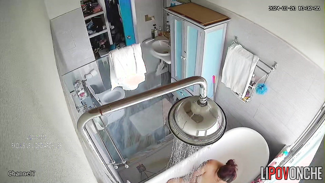 Mature MILF takes a shower and masturbates while sitting in the bathtub