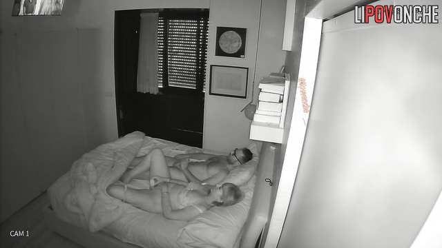 Guy in glasses teasing his girlfriend in the bed