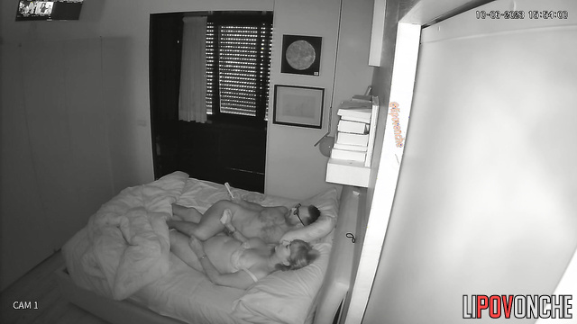 Guy in glasses teasing his girlfriend in the bed