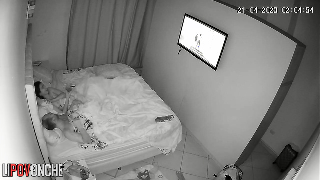 Couple relaxing with glasses of wine in their bed