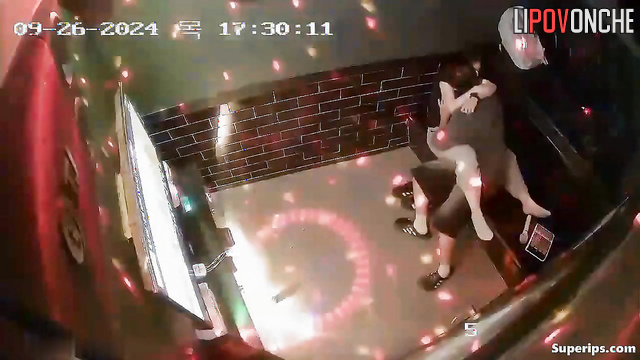 Asian couple having fun at karaoke club (hot petting)