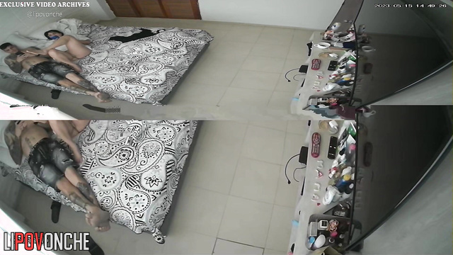 Tattooed couple chilling with phones on the bed