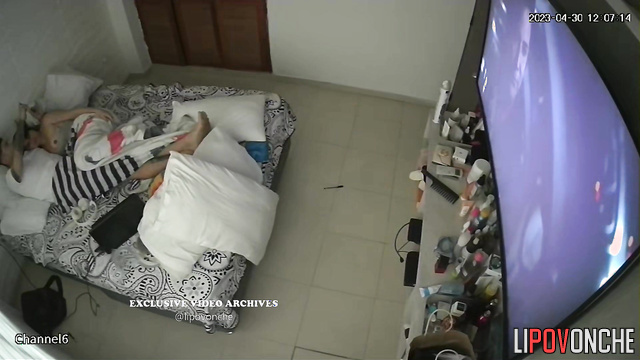Tattooed boyfriend hugging his girlfriend in the bed
