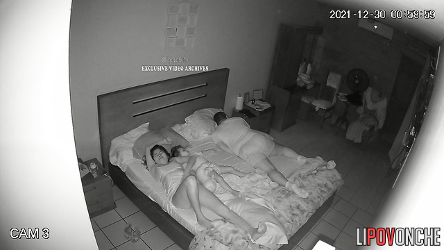Close relatives chilling together on the bed in the morning