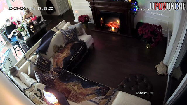 Blonde and her boyfriend chatting near the fireplace