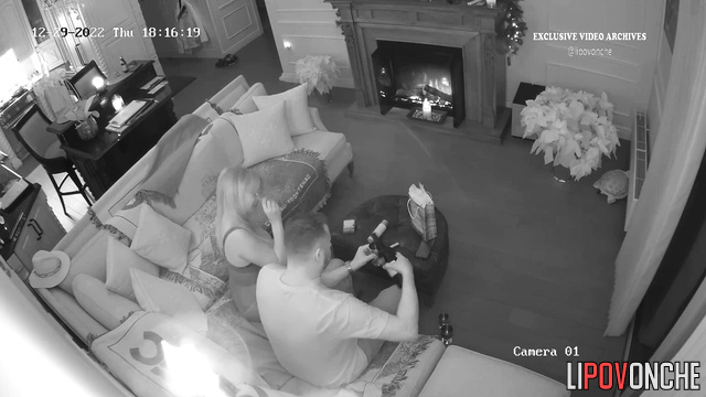 Blonde and her boyfriend chatting near the fireplace