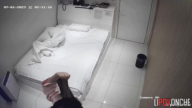 Asian girl drying her hair (and being watched)