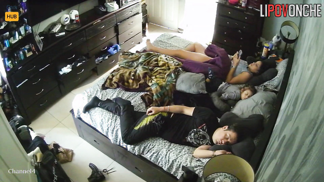 Couple minding their own business while lying on the bed