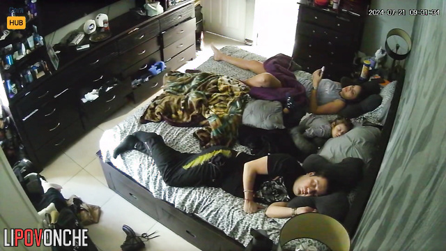 Couple minding their own business while lying on the bed