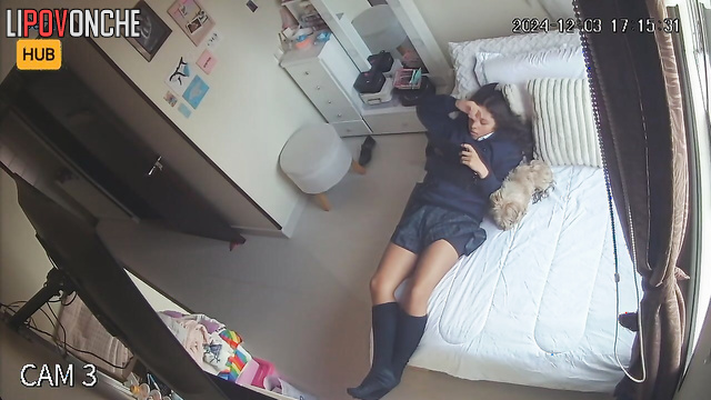 Cute schoolgirl relaxing with tablet on the bed