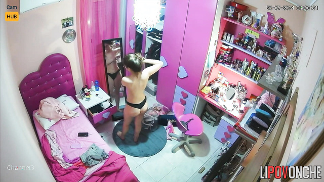 Long-haired skinny girl looking at her sexy body in mirror