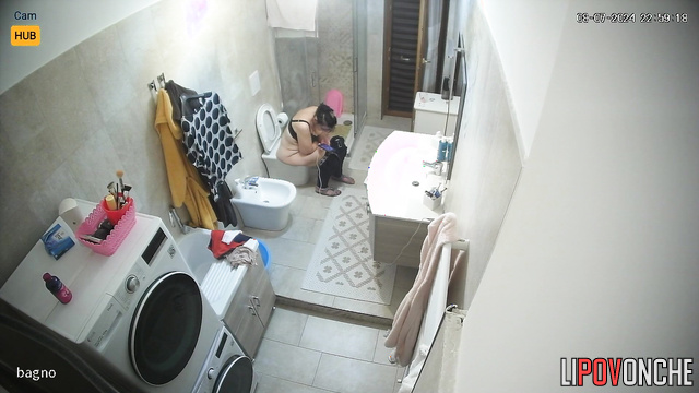 Chubby woman sitting on the toilet and listening to music