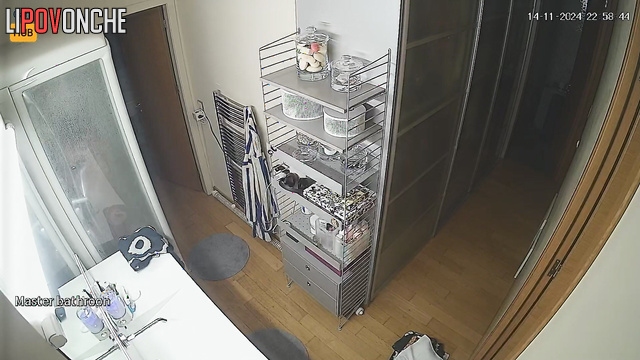 She washes herself and does not suspect that she is being watched