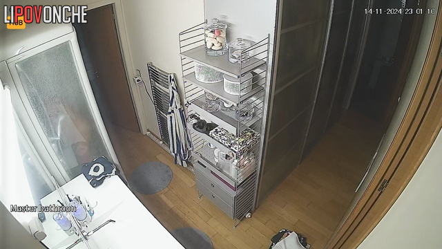 She washes herself and does not suspect that she is being watched