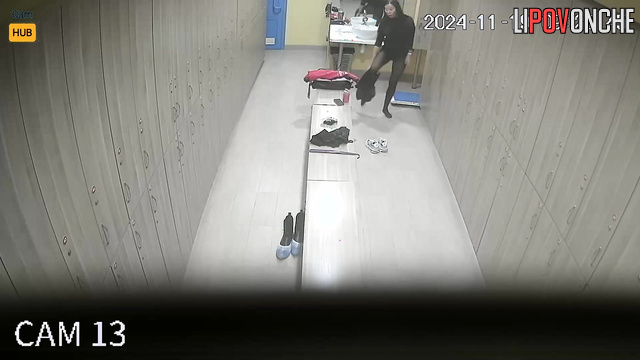 Long-haired russian girl changing clothes in the locker room