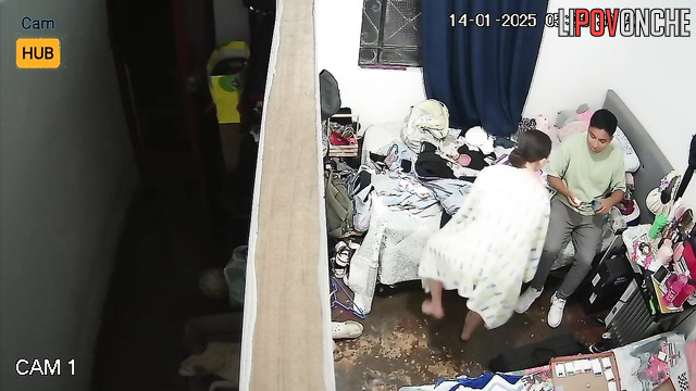 Topless girl dressing and chatting with her boyfriend