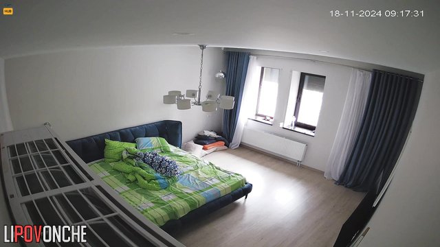 Lonely lady making her bed after sleep, hidden camera
