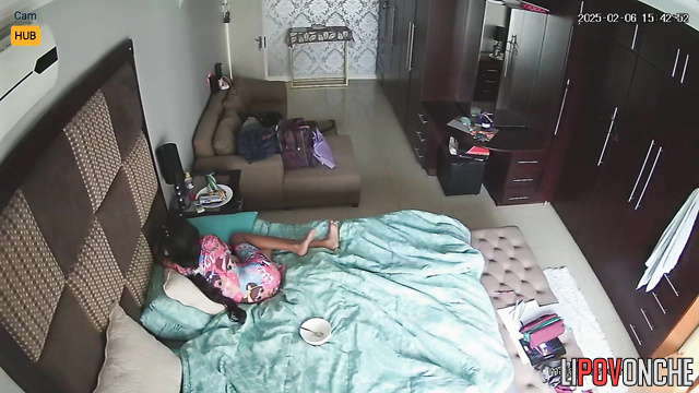 Sisters chilling now - one is lying on the bed and the other is getting dressed