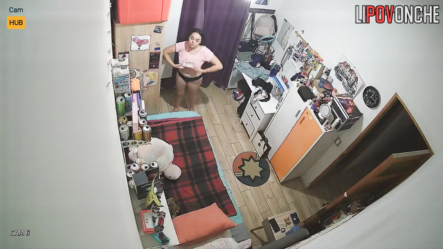 Pretty and lonely brunette dressing in their cozy bedroom
