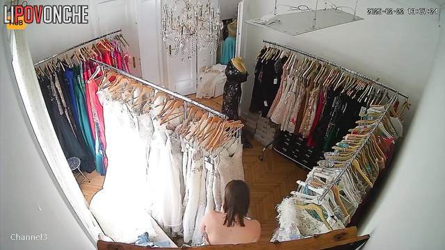 A big-breasted Serbian bride tries on her wedding gown