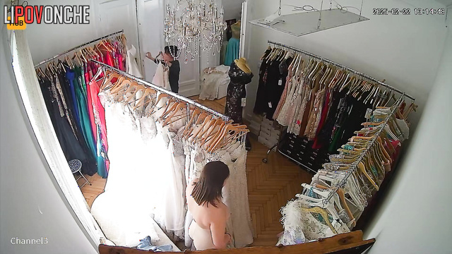 A big-breasted Serbian bride tries on her wedding gown
